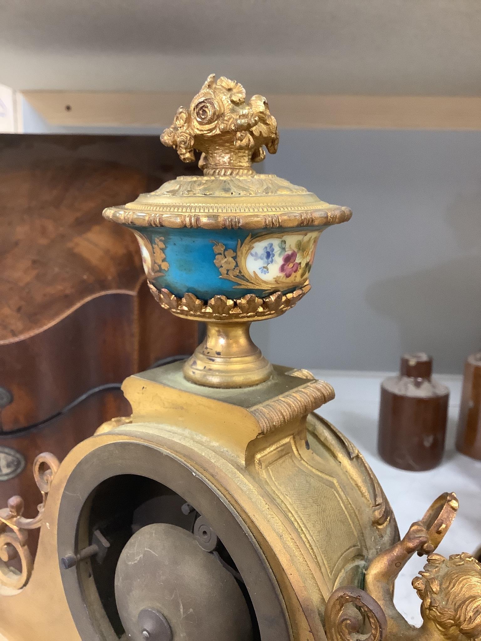 A 19th century French ormolu and Sevres style porcelain mounted mantel clock, with key and pendulum, 35 cm high